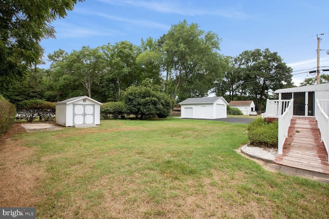 view of yard with a garage and a storage unit