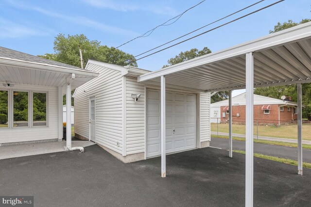 view of parking / parking lot with a carport and a garage