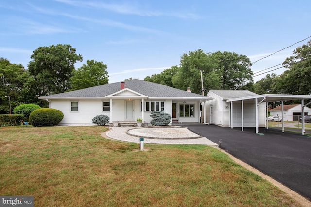 ranch-style home featuring a carport and a front lawn