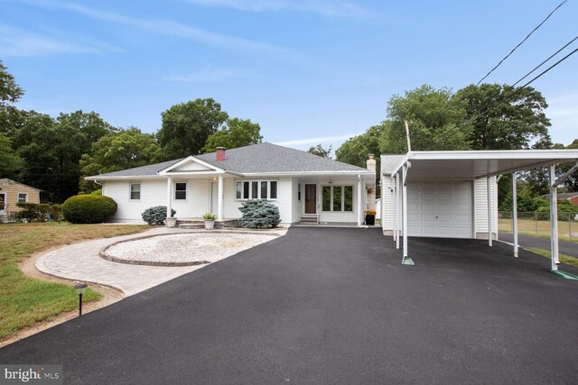 ranch-style home with a garage and a carport