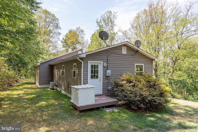 rear view of property featuring a yard