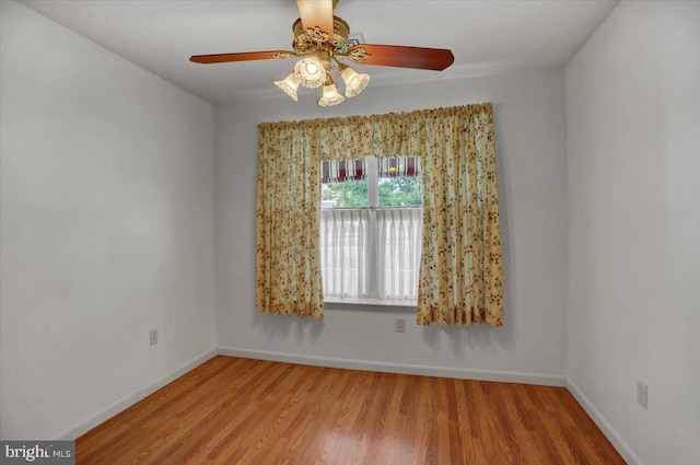 empty room with light wood-type flooring and ceiling fan