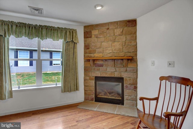 living area featuring a fireplace and hardwood / wood-style flooring