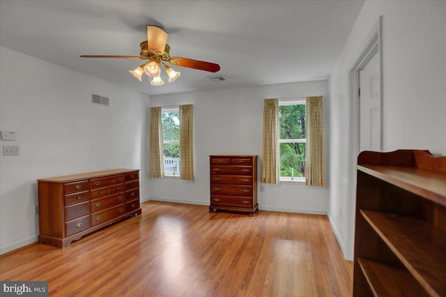 bedroom with multiple windows, ceiling fan, and light wood-type flooring