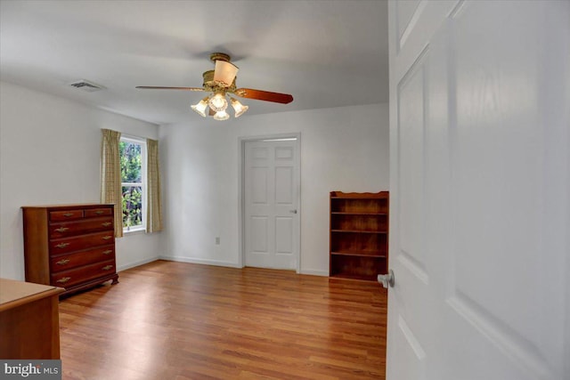 unfurnished bedroom with ceiling fan and light hardwood / wood-style floors