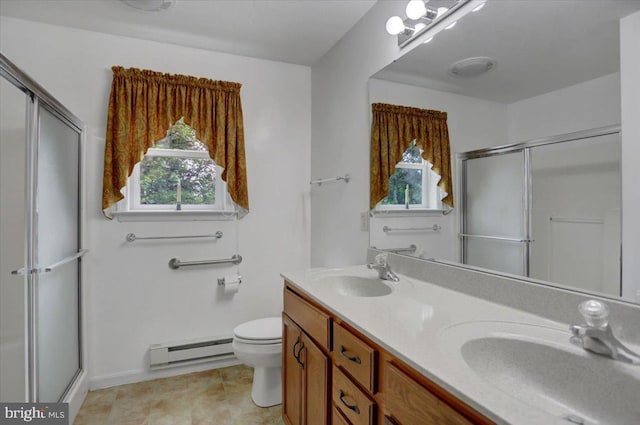 bathroom featuring vanity, a shower with door, toilet, and baseboard heating