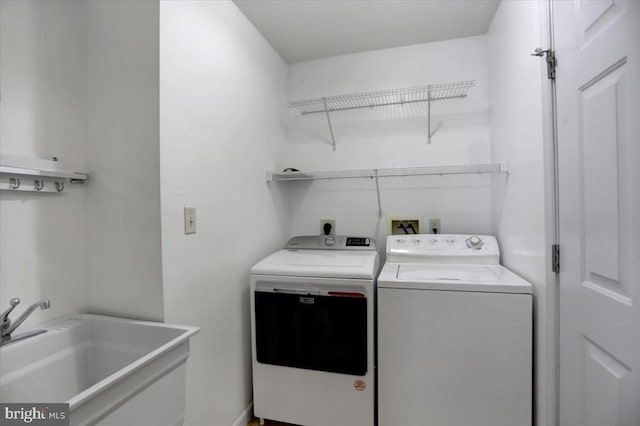 clothes washing area featuring washing machine and clothes dryer and sink