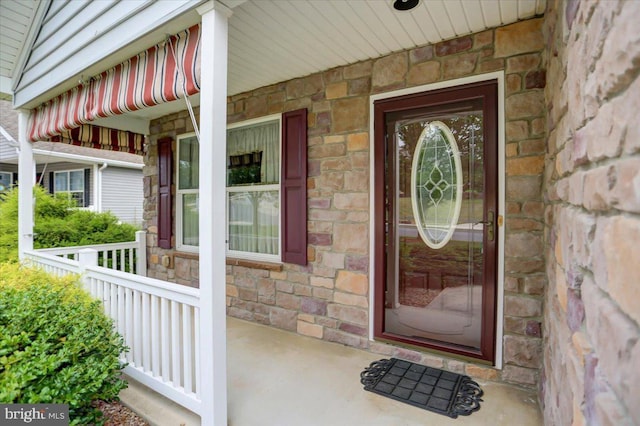 view of exterior entry featuring a porch