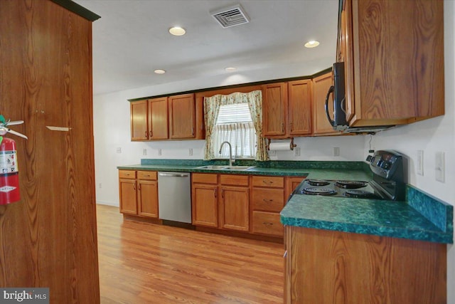 kitchen with light hardwood / wood-style floors, sink, and appliances with stainless steel finishes