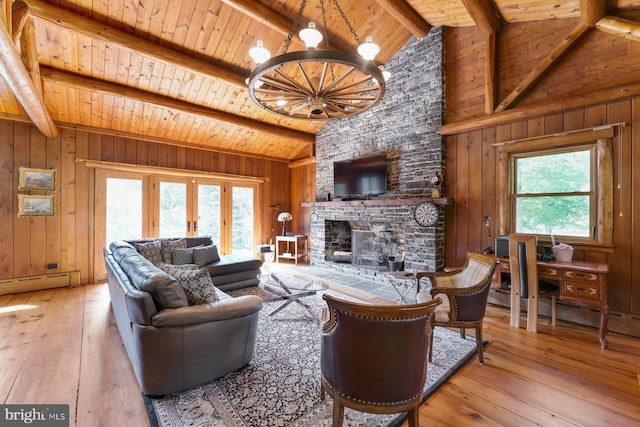 living room featuring beam ceiling, a wealth of natural light, and wood ceiling