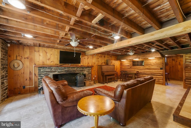 living room with beamed ceiling, rustic walls, ceiling fan, and wooden ceiling