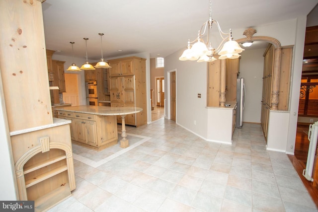 kitchen with a kitchen breakfast bar, hanging light fixtures, a kitchen island, stainless steel appliances, and a chandelier