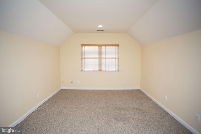 bonus room with carpet flooring and lofted ceiling