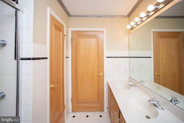 bathroom featuring tile patterned flooring, vanity, tile walls, and ornamental molding