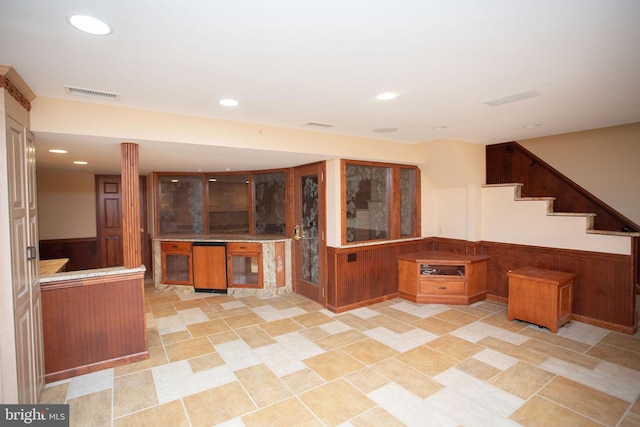 kitchen featuring kitchen peninsula and wooden walls