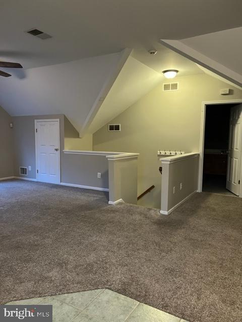 bonus room featuring carpet, vaulted ceiling, and ceiling fan