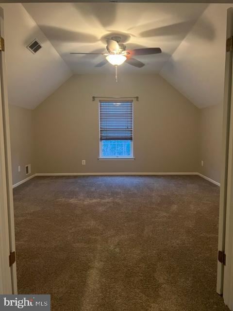 bonus room featuring dark carpet, vaulted ceiling, and ceiling fan