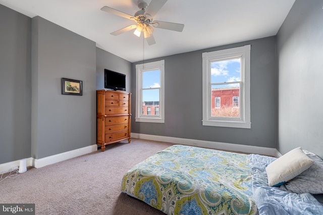 bedroom featuring ceiling fan and light carpet