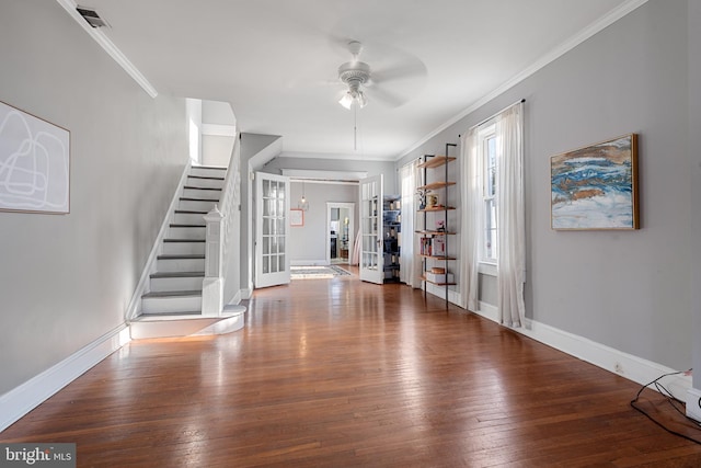 foyer entrance with hardwood / wood-style floors, ceiling fan, ornamental molding, and french doors