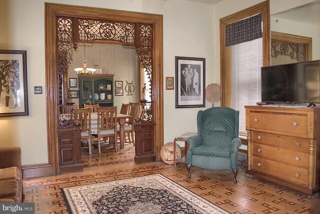 living area with a notable chandelier and light hardwood / wood-style flooring