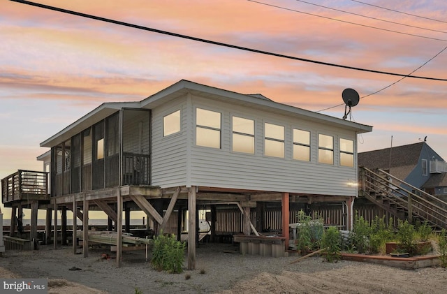 view of back house at dusk