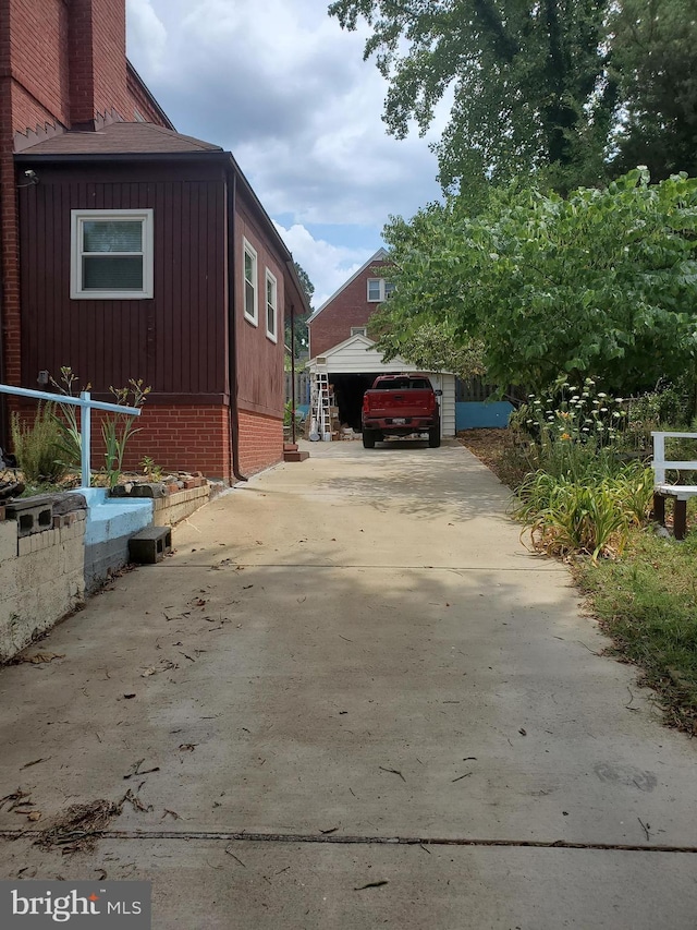 view of side of property featuring a garage and an outdoor structure