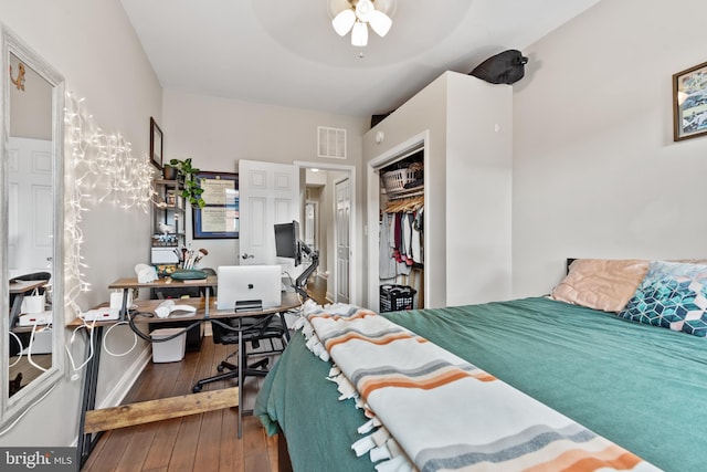 bedroom with hardwood / wood-style floors, ceiling fan, and a closet