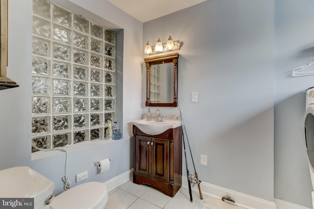 bathroom with tile patterned flooring, vanity, and toilet