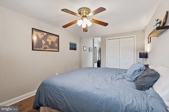 bedroom featuring ceiling fan, a closet, and dark hardwood / wood-style floors