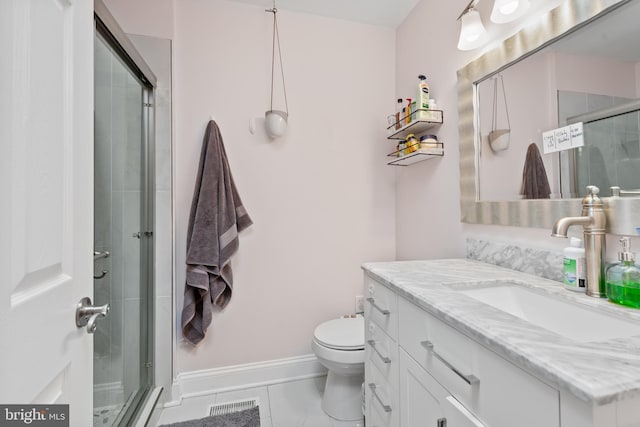 bathroom with vanity, an enclosed shower, and toilet