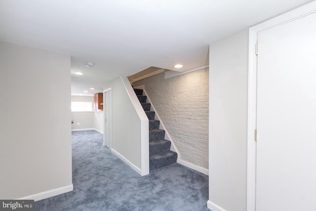 staircase featuring carpet