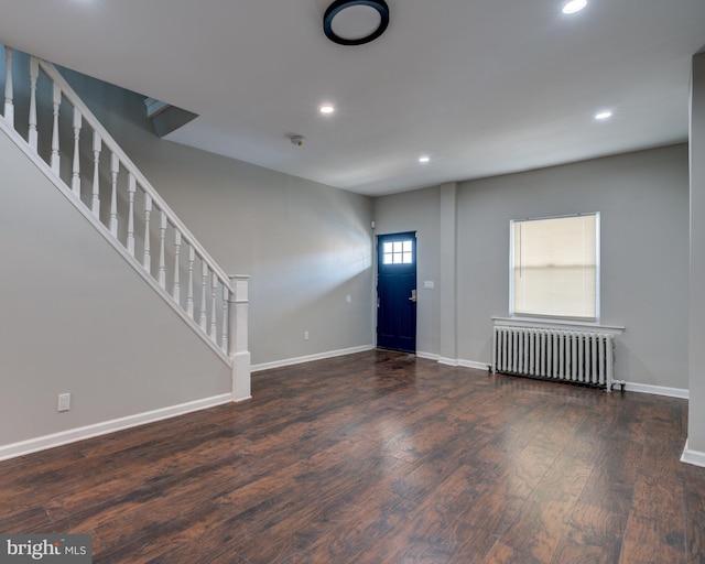 entrance foyer featuring radiator heating unit and dark wood-type flooring