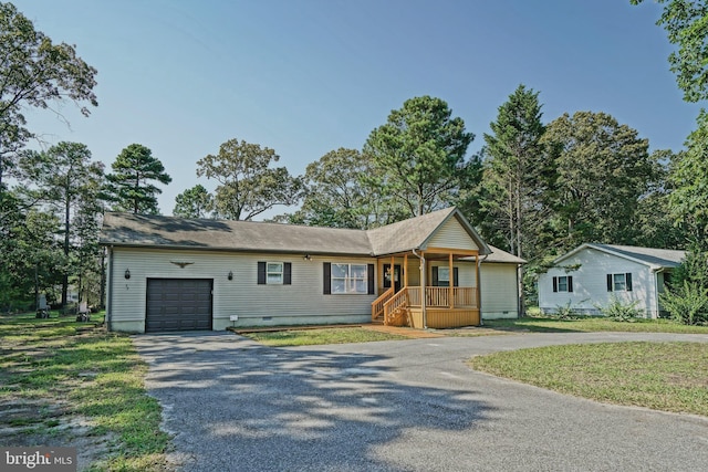 ranch-style house featuring crawl space, an attached garage, and aphalt driveway