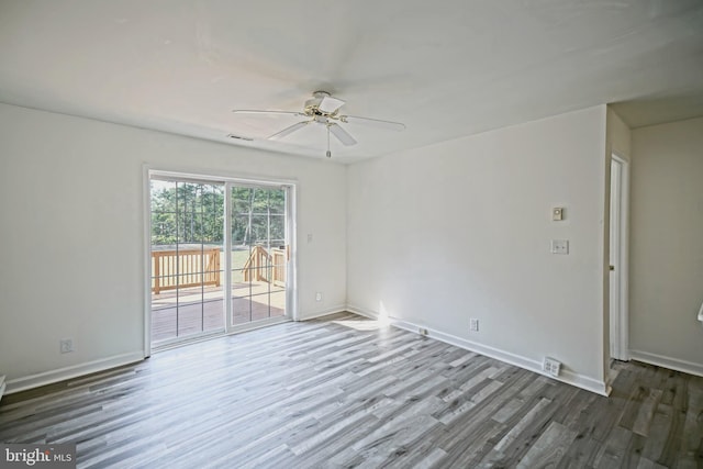 unfurnished room with ceiling fan and dark hardwood / wood-style flooring