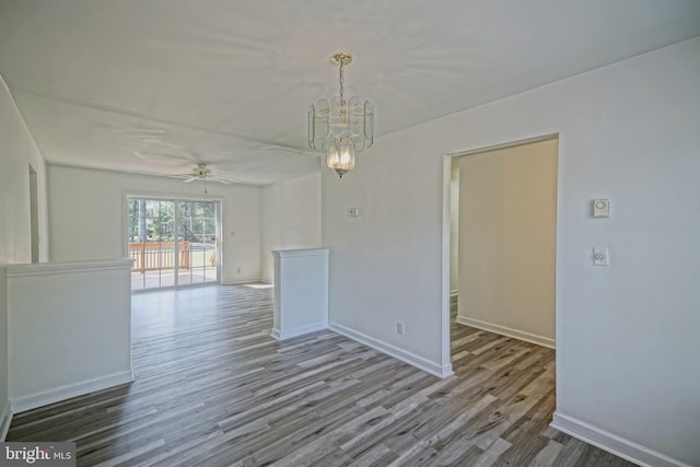 unfurnished room featuring ceiling fan with notable chandelier and wood-type flooring