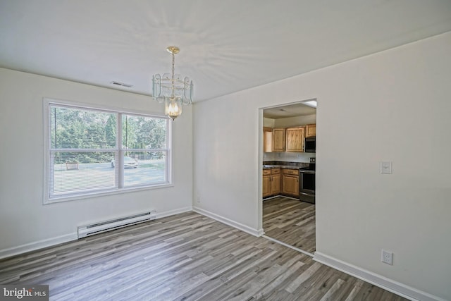 unfurnished dining area featuring a baseboard heating unit, a chandelier, and light hardwood / wood-style floors