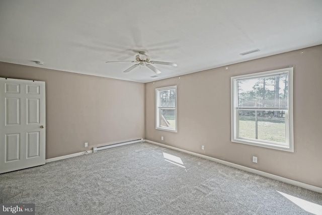 carpeted spare room with ceiling fan and a baseboard radiator