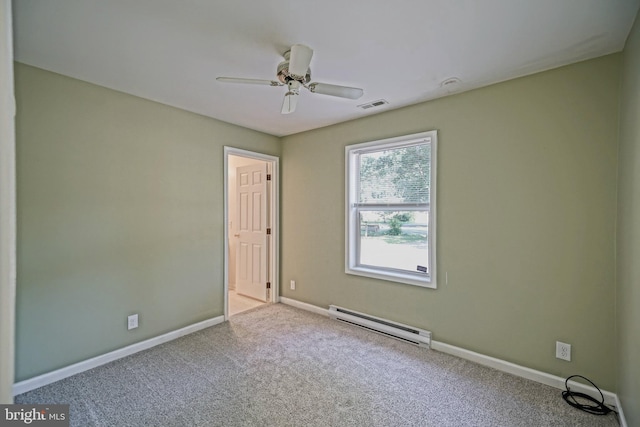 carpeted spare room with ceiling fan and a baseboard heating unit