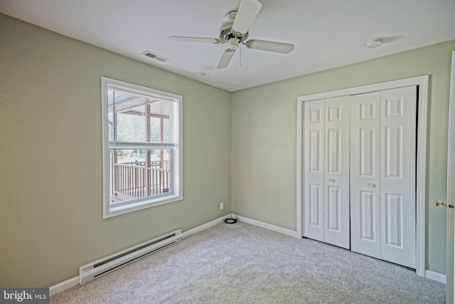 unfurnished bedroom featuring ceiling fan, a baseboard radiator, a closet, and light carpet