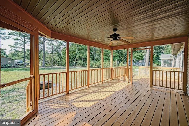 deck with ceiling fan and a lawn