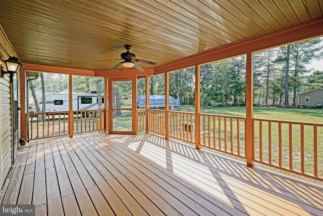 unfurnished sunroom with ceiling fan and plenty of natural light