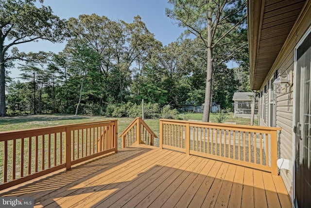 wooden terrace with a lawn