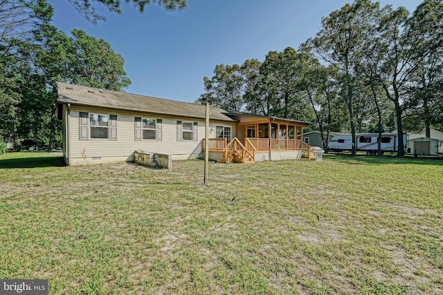 rear view of house featuring a lawn