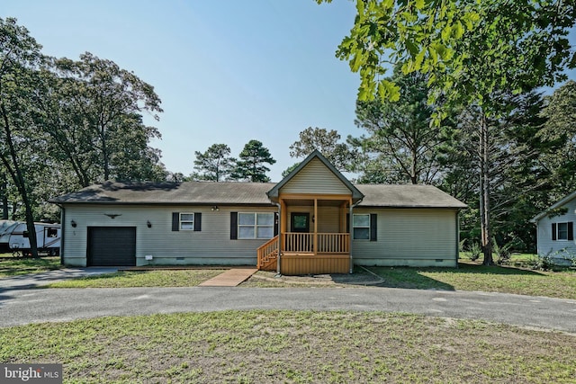 ranch-style home with a garage and a front yard