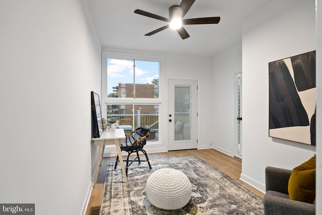 office with light hardwood / wood-style floors and ceiling fan