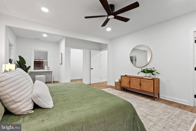 bedroom with ceiling fan and hardwood / wood-style floors