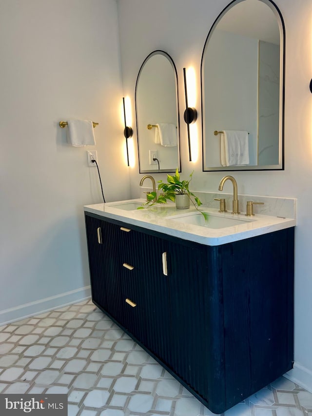 bathroom with tile patterned flooring and dual bowl vanity