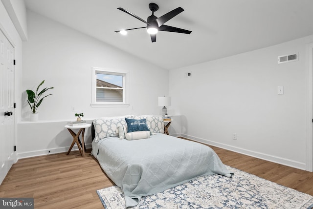 bedroom featuring wood-type flooring, lofted ceiling, and ceiling fan