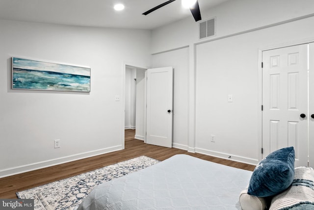 bedroom featuring hardwood / wood-style flooring, vaulted ceiling, and ceiling fan