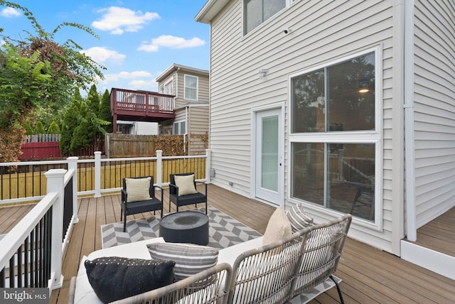 wooden terrace with an outdoor hangout area